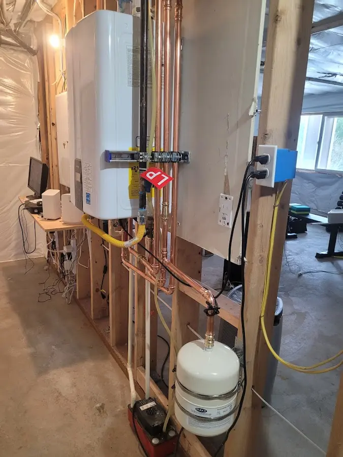 Licensed plumber repairing a kitchen sink in Camillus